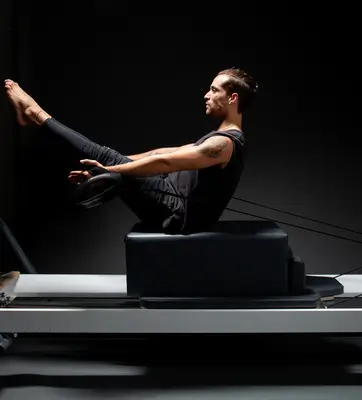 Person performing Pilates on a reformer machine alongside a customer testimonial praising Avenir fitness studio for creativity, community, and over 500 classes taken.